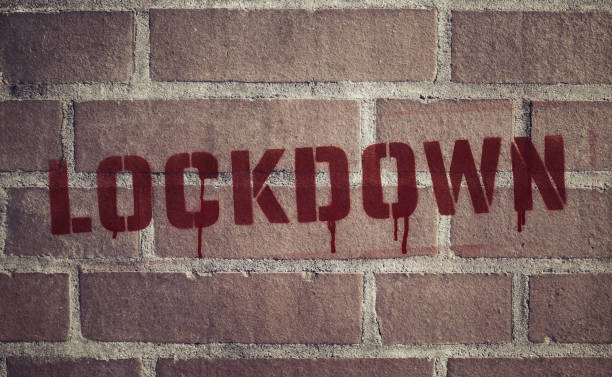 "Lockdown" Stencil Spray-Painted on Brick Wall stock photo