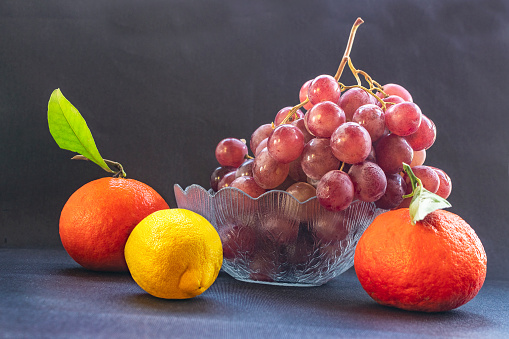 Still life of colorful fruits on the black background.