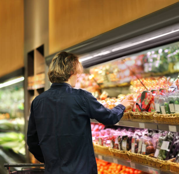 istock Young man buying vegetables at the market 1204696147