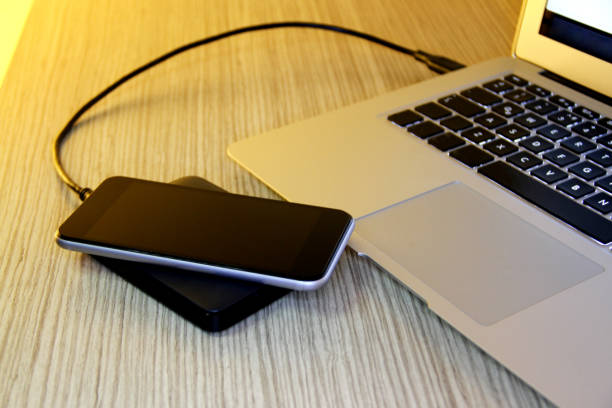 istock smartphone charging wireless charging stock photos 1204696755