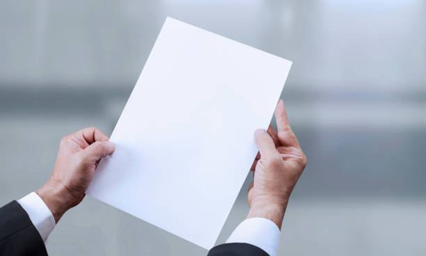 istock hand holding blank paper at office 1204697464