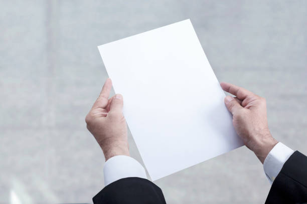 istock hand holding blank paper at office 1204697470