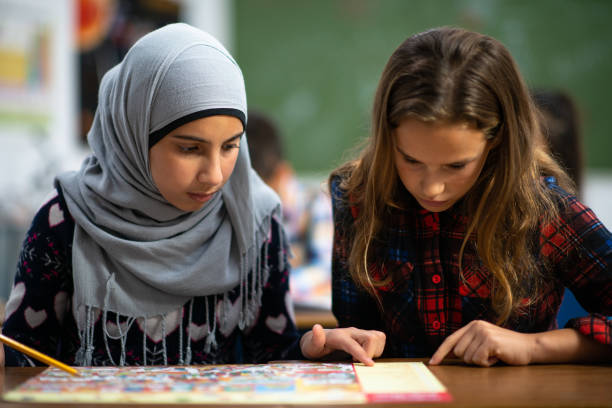 istock Multi-Ethnic Elementary Girls Studying in Class stock photo 1204702622