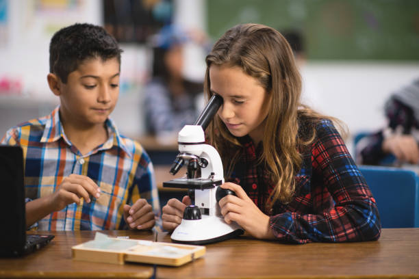 istock Multi-Ethnic Group of Students Working With a Microscope stock photo 1204702646