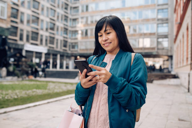 istock Asian woman shopping and using phone 1204704376