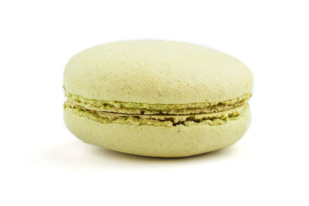 istock Single green macaron or macaroon cake isolated on white background. side view, close up, macro. 1204707697