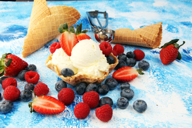 istock Vanilla ice cream scoops with fresh berries. Strawberries, raspberries with ice cream 1204708385