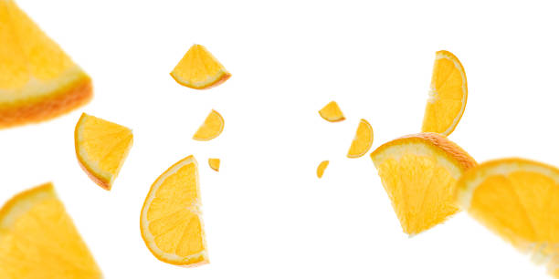 istock Orange background. Citrus fruit tangerine slices falling on white with clipping path. 1204709617