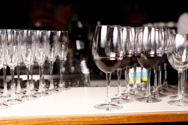 Empty glasses and glasses with red wine at event catering