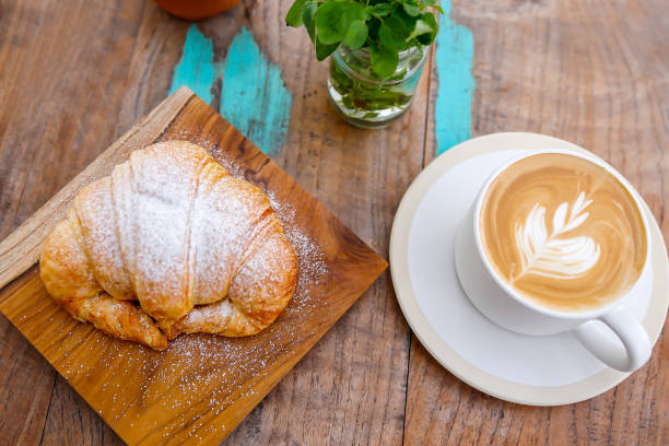 istock Italian breakfast with hot cappuccino and croissant 1204713196