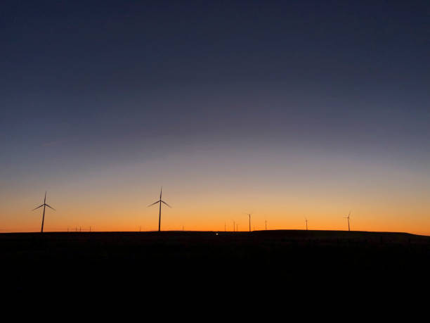 istock Catching sunrise on a wind farm 1204715906