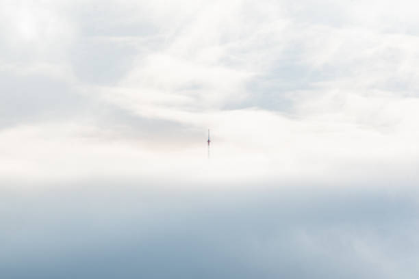 cell tower in the mountains above the clouds lighthouse minimalist concept empty space text