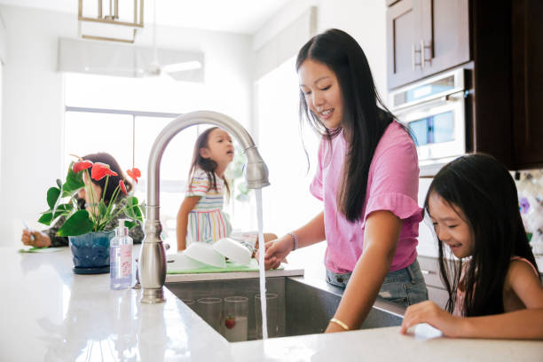istock Mom doing dishes in the kitchen. 1204716235