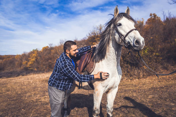 istock Young man taking good care on horse 1204721501