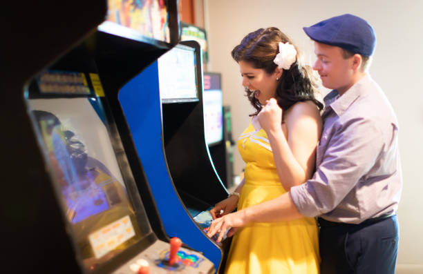 Couple having a good time with vintage arcade games