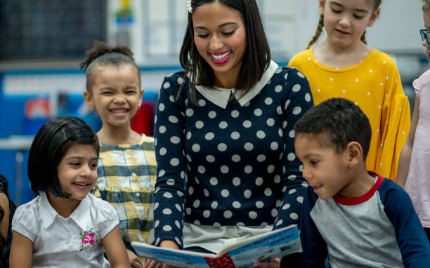 istock Elementary Teacher Reading to Her Class stock photo 1204727410