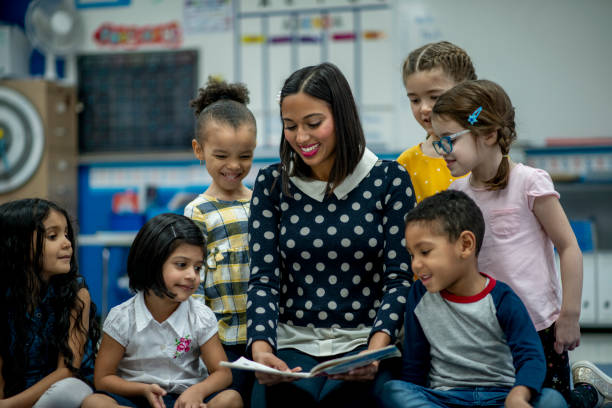 istock Elementary Teacher Reading to Her Class stock photo 1204727423