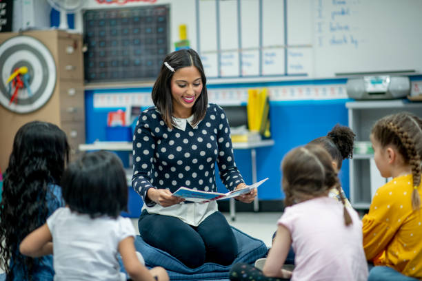 istock Elementary Teacher Reading to Her Class stock photo 1204727431
