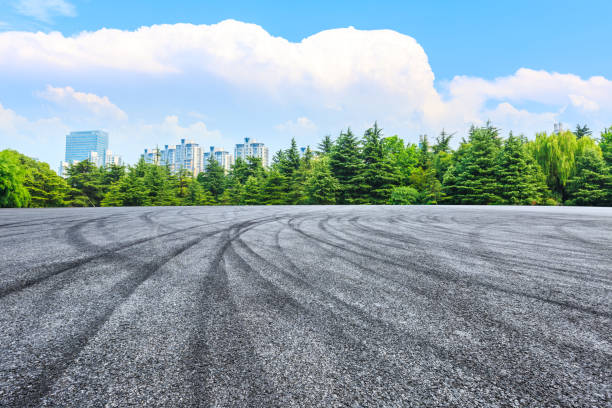 istock Asphalt road and green forest under blue sky. 1204731580