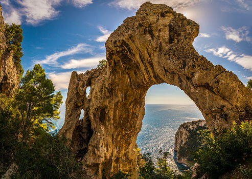The Arco Naturale is a natural arch on the east coast of the island of Capri. Dating from the Paleolithic age, it is the remains of a collapsed grotto. The arch spans 12 m at a height of 18 m above ground and consists of limestone.
