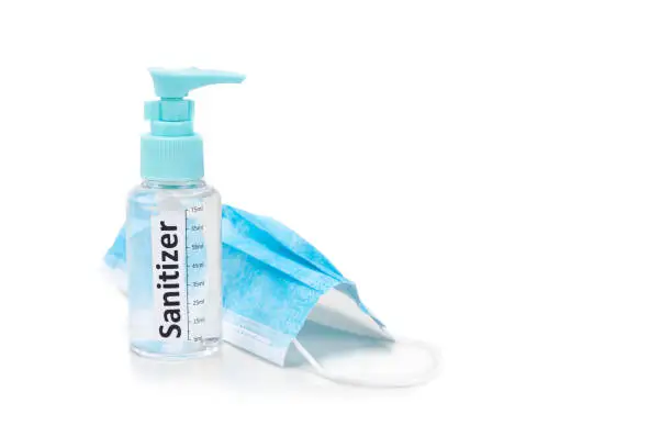 Photo of Hand sanitizer spray and surgical facial mask as protection against influenza