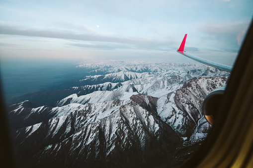 Mountains view through window of aircraft