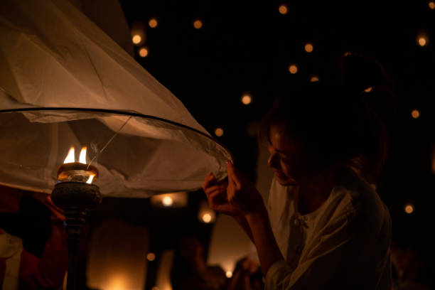 istock Thai Asian woman holding Yi Peng lantern 1204736388