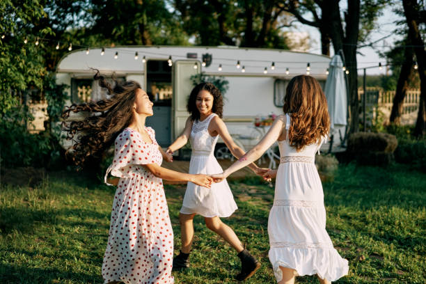 istock Happy beautiful women dancing outdoors on picnic 1204747503