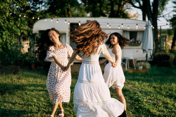 istock Happy beautiful women dancing outdoors on picnic 1204747504