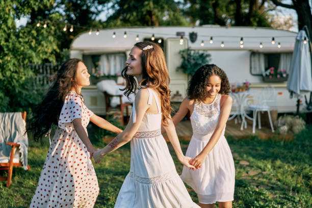 istock Happy beautiful women dancing in circle during a picnic 1204747508