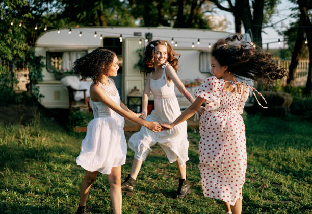 istock Happy beautiful women dancing outdoors on picnic 1204747509