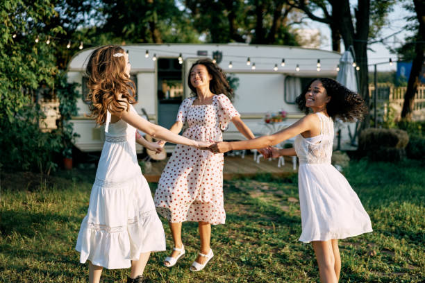 istock Happy beautiful women dancing outdoors on picnic 1204747512