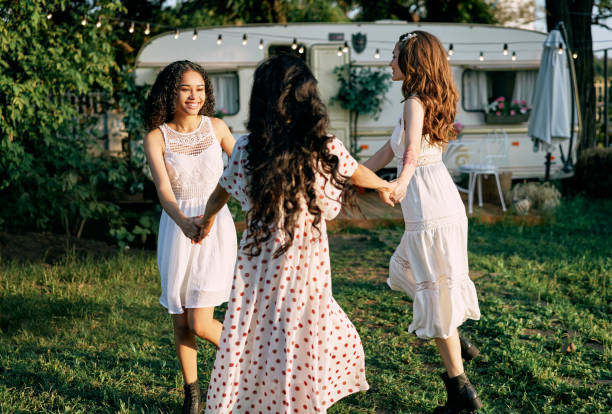 istock Happy beautiful women dancing outdoors on picnic 1204747516