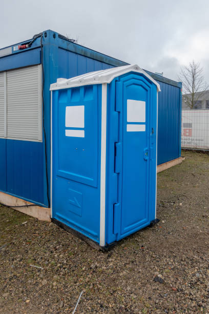 istock a construction site a blue construction site toilet stands next to a blue container 1204754224