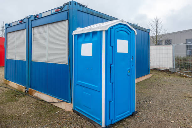 istock a construction site a blue construction site toilet stands next to a blue container 1204754234