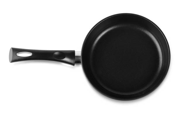 istock The black fry pan over white background 1204754966