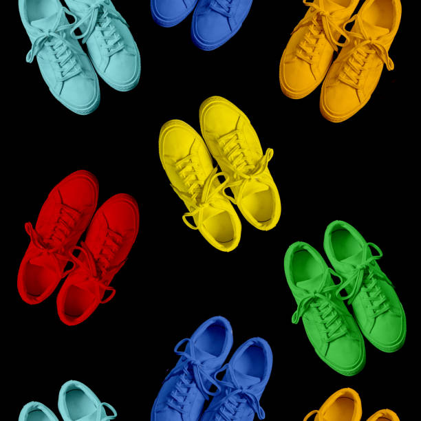 Short low brigt multicolored sneakers on a Black background. Seamless pattern. Rainbow