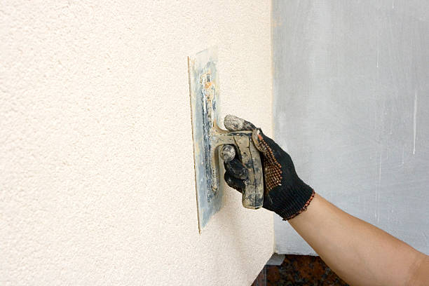 istock Close up of hand applying plaster to wall 120475813