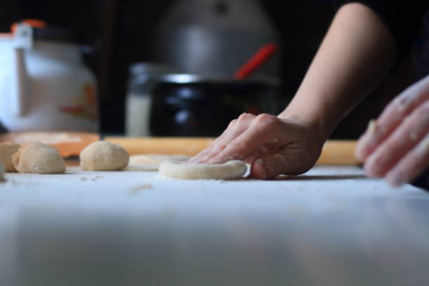 istock women's hands roll out the dough for dumplings 1204758284