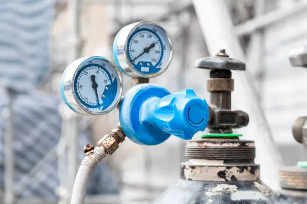 Close up of pressure gauges on oxygen tank with valve of welding equipment acetylene gas cylinder for steel Industrial and metal working construction.