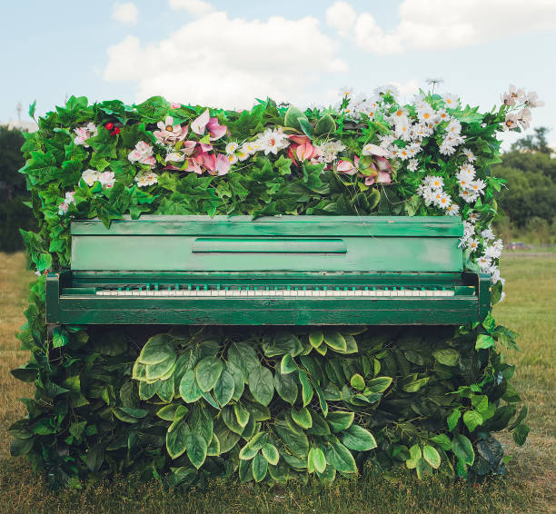 old piano in beautiful flowers