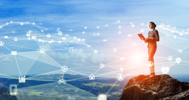 istock Communication network concept. Young businesswoman on the mountain top. 1204762017