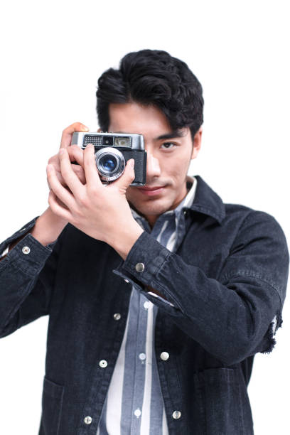 istock The young man is holding a camera 1204762169