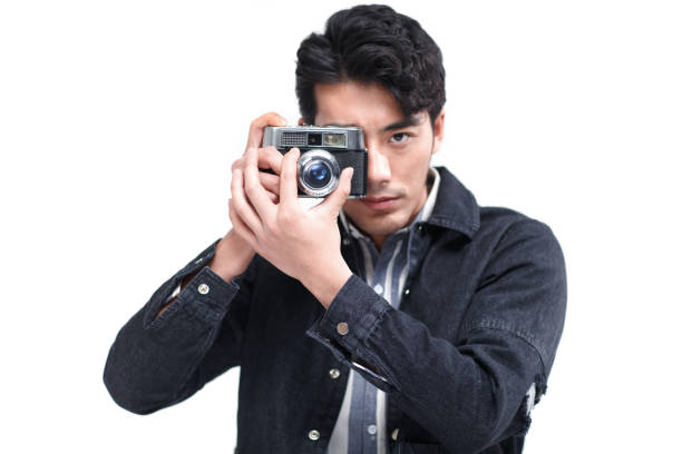 istock The young man is holding a camera 1204762174