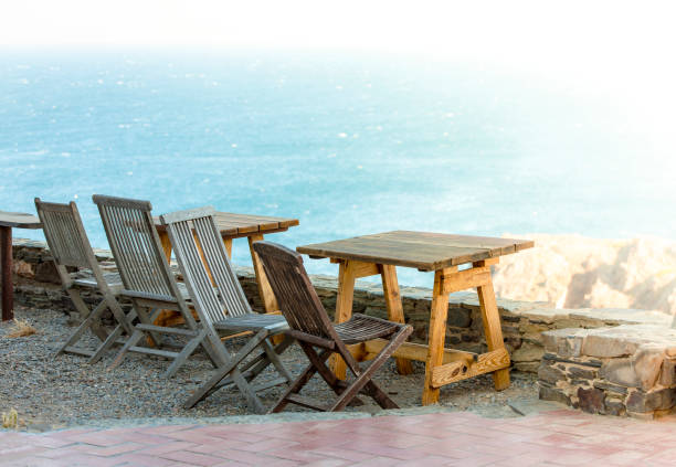 istock Old wooden table and chair at the seafront 1204763290