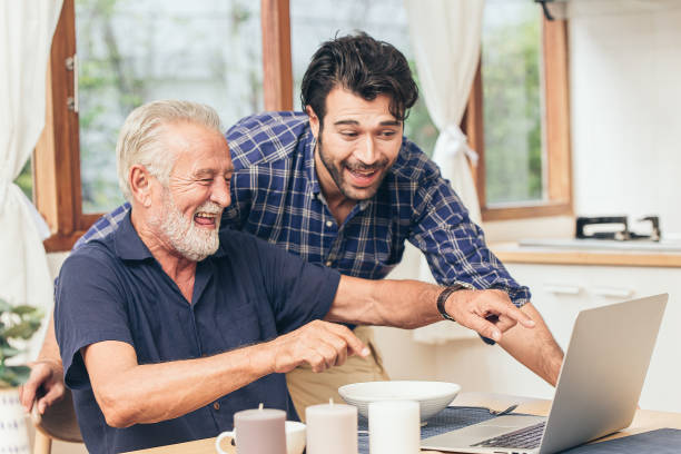 istock old man fun smile happy to looking at laptop with son. using communication technology for family happiness elder home care to connection other concept 1204763410