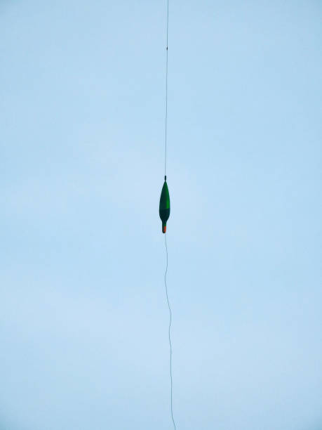 istock Fishing blinker in the air in front of blue sky 1204771470