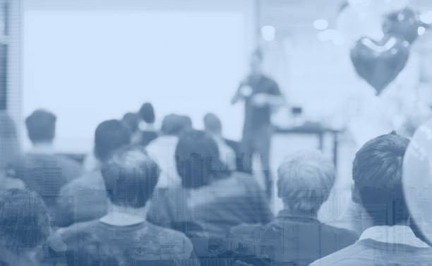 istock Speech given by professional speaker on stage at corporate conference. Executive manager giving presentation  to audience at leadership workshop for entrepreneurs. People receiving business education. 1204771495