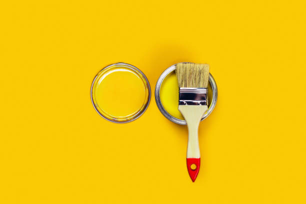 istock Colored background with paint jar and brush. 1204773387