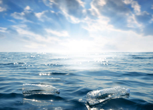 istock Plastic bottles floating in the ocean. 1204773618